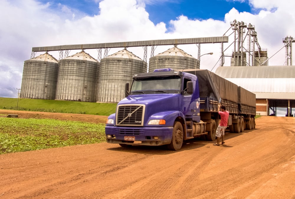 Sojamax truck at agricultural facility with grain silos